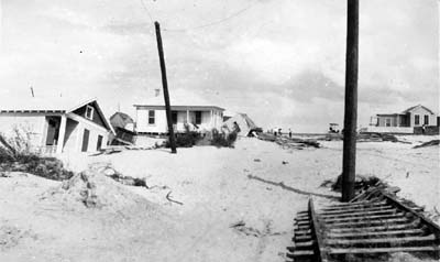 Photograph of wrecked houses and street railway track 