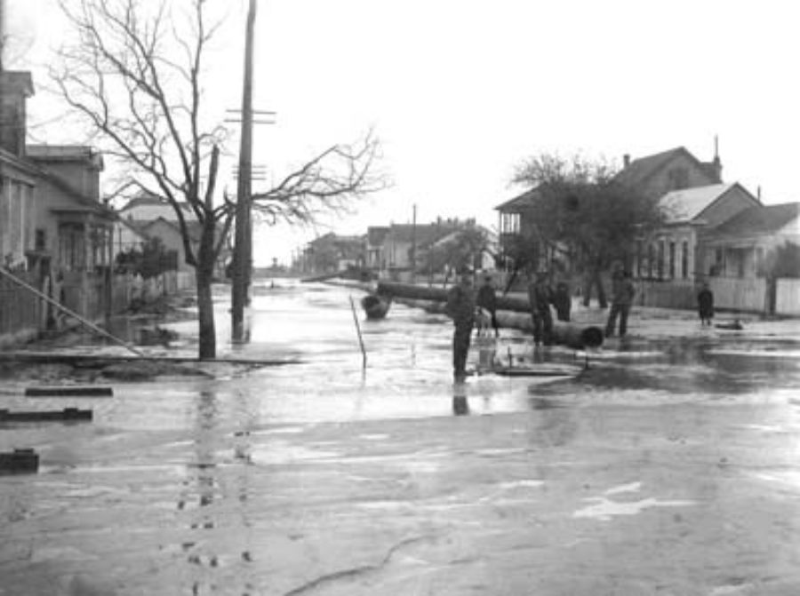 G-59261FF7-1 The Dredge's discharge pipe end, showing the sand filling of property and street, the residences