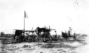 G-1771FF10.1-1 Group of workers with wagon at camp site