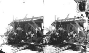 SC#194-14 Workmen taking break under lean-to shelter.