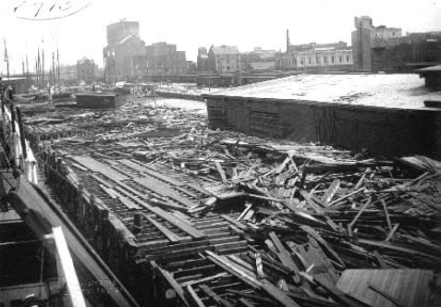 G-1771FF2.2-4 Debris and freight car strewn along wharf