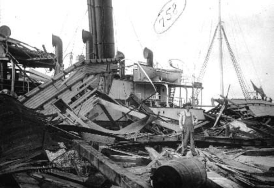 G-1771FF2.2-8 Man standing on board wrecked steamship