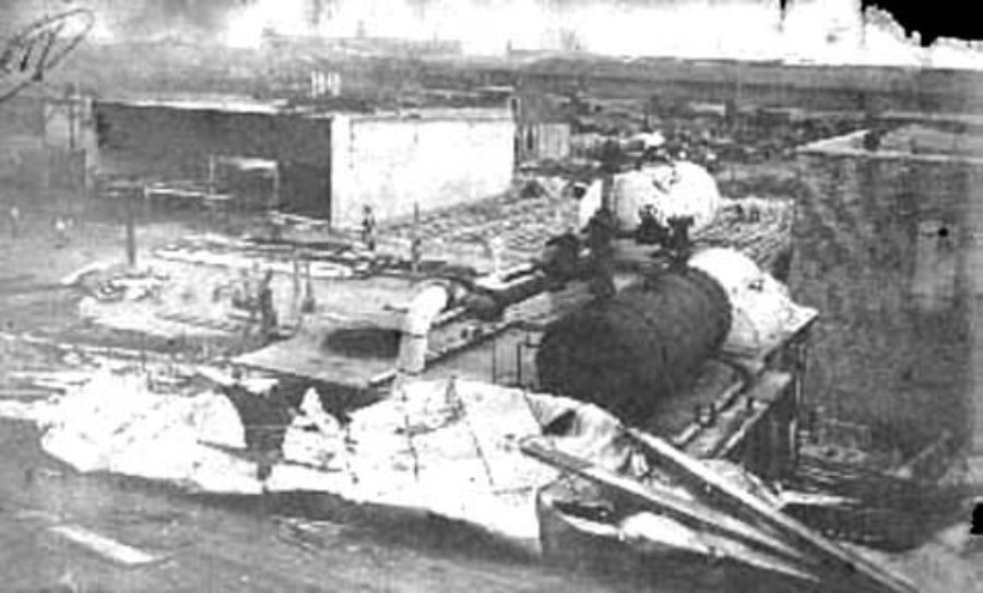 G-1771FF6.4-13 Ruins of business, showing storage tanks