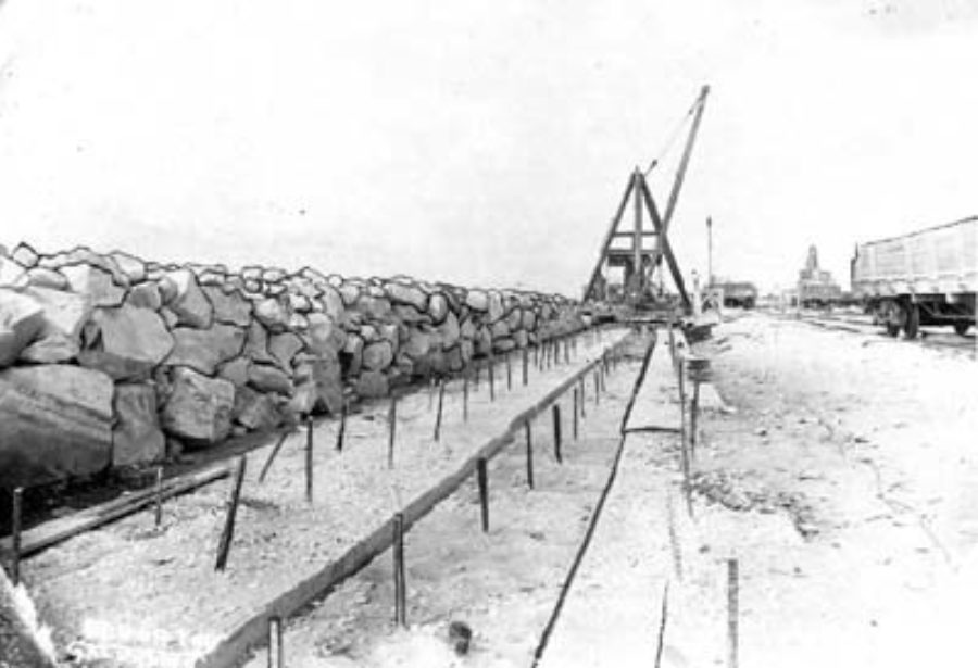 G-5925.1FF2-11 Derrick laying riprap along foundation of Seawall