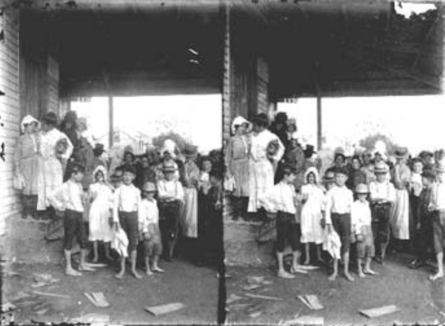 SC#194-38 Women and children waiting outside store for issuance of relief supplies.